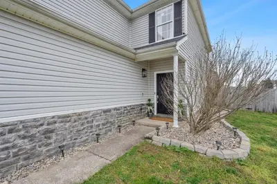 a house with a window and a tree in front of it at Spacious King Suite, Game Room, Patio, Firepit in Lexington
