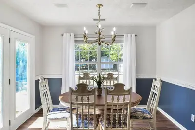 a dining room with a table and chairs and a window at Spacious King Suite, Horses, Fire Pit, Garage in Lexington