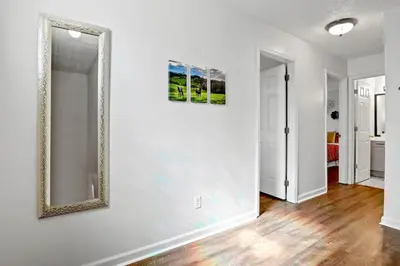 a mirror on a white wall in a room at Spacious King Suite, Horses, Fire Pit, Garage in Lexington