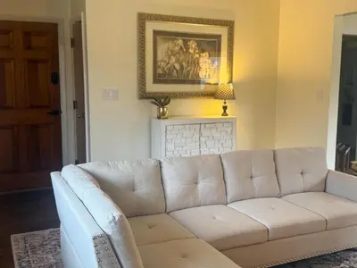 a white couch in a living room with a fireplace at 2 bedroom hot tub home near NKU in Cold Spring