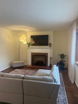 a living room with a couch and a fireplace at 2 bedroom hot tub home near NKU in Cold Spring
