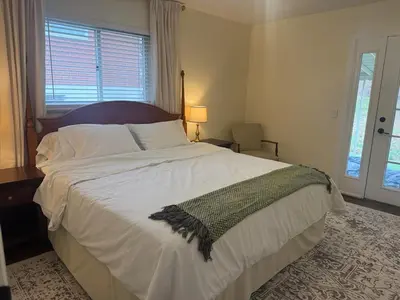 a bedroom with a large white bed and a window at 2 bedroom hot tub home near NKU in Cold Spring