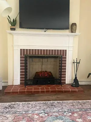 a fireplace with a television on top of it at 2 bedroom hot tub home near NKU in Cold Spring
