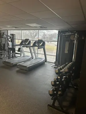 a gym with several tread machines in a room at Cozy 1 bedroom apartment near downtown Cincinnati in Cincinnati