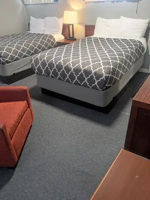 a room with two beds and a couch at Southland Motor Lodge Hotel in Woodhaven