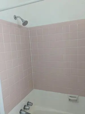 a bathroom with a sink and a pink tiled wall at Southland Motor Lodge Hotel in Woodhaven