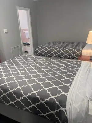 a bedroom with a bed with a black and white comforter at Southland Motor Lodge Hotel in Woodhaven