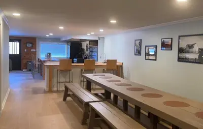 a living room with a table and a kitchen at Slice of Petersburg