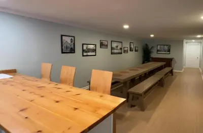 a dining room with a long wooden table and chairs at Slice of Petersburg