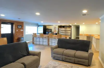 a living room with a couch and a kitchen at Slice of Petersburg