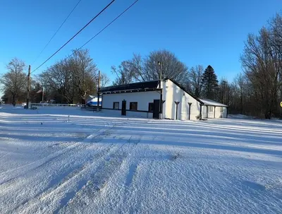 a snow covered field with a building in the background at Slice of Petersburg