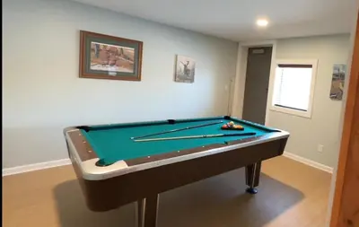 a room with a pool table in a room at Slice of Petersburg