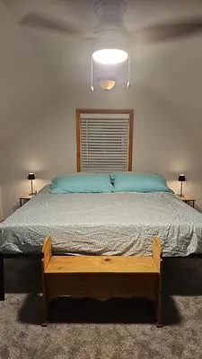 a bedroom with a large bed with a wooden frame at Spacious Family Retreat with ADA Ramp and ADA bathroom in Maumee