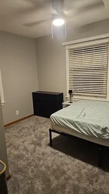 a bedroom with a bed and a dresser and a window at Spacious Family Retreat with ADA Ramp and ADA bathroom in Maumee