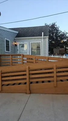 a wooden fence in front of a house at Spacious Family Retreat with ADA Ramp and ADA bathroom in Maumee