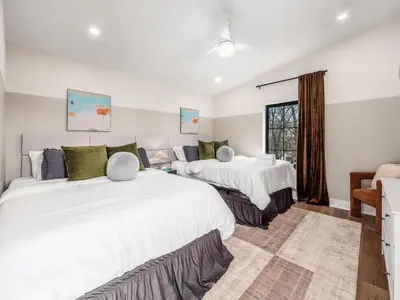 a bedroom with two beds and a window at Rooftop Patio, Hot Tub and Games City Escape in Columbus