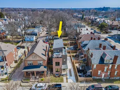 a yellow arrow on top of a house in a neighborhood at Rooftop Patio, Hot Tub and Games City Escape in Columbus