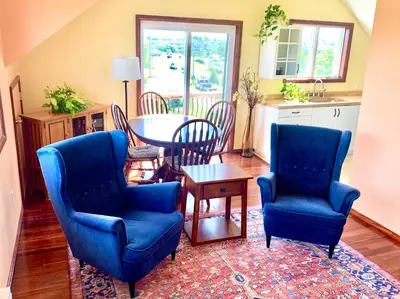 a living room with two blue chairs and a table at Aniyor Apartment Loft