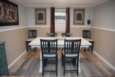 a dining room with a white table and chairs at Huber Heights Home w/Hot Tub near Rose Music/WPAFB in Dayton