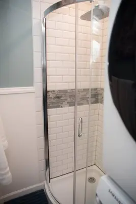 a shower with a glass door in a bathroom at Huber Heights Home w/Hot Tub near Rose Music/WPAFB in Dayton