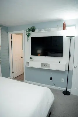a bedroom with a flat screen tv on a wall at Huber Heights Home w/Hot Tub near Rose Music/WPAFB in Dayton
