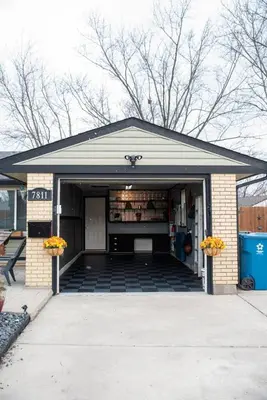 a building with a garage with flowers in it at Huber Heights Home w/Hot Tub near Rose Music/WPAFB in Dayton