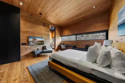 a bedroom with a bed and a wooden wall at Cincinnati Vista - Rooftop, Balcony & Fireplace in Cincinnati