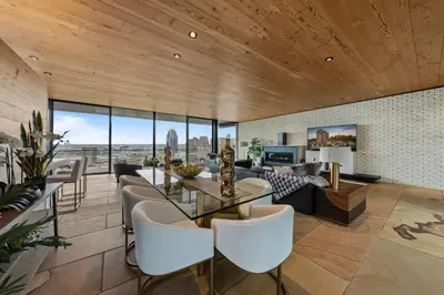 a living room with a glass table and white chairs at Cincinnati Vista - Rooftop, Balcony & Fireplace in Cincinnati