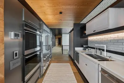 a kitchen with stainless steel appliances and wooden ceilings at Cincinnati Vista - Rooftop, Balcony & Fireplace in Cincinnati