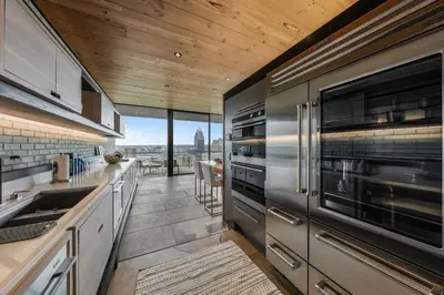 a kitchen with stainless steel appliances and wooden ceilings at Cincinnati Vista - Rooftop, Balcony & Fireplace in Cincinnati
