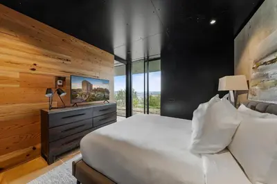 a bedroom with a large bed and a wall of windows at Cincinnati Vista - Rooftop, Balcony & Fireplace in Cincinnati