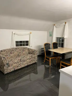 a living room with a couch and a table at Cozy Apartment w Garage in Salem