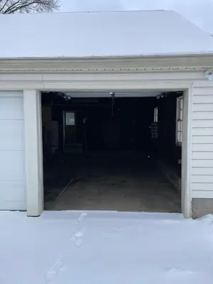 a garage with an open door with snow on the ground at Cozy Apartment w Garage in Salem