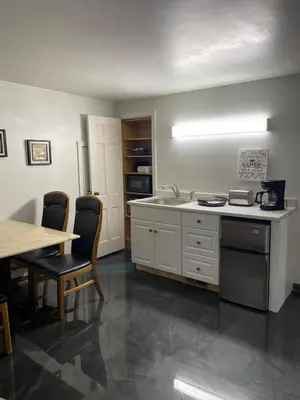 a kitchen with a sink and a table with chairs at Cozy Apartment w Garage in Salem