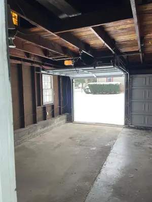 a garage with a white garage door in a building at Cozy Apartment w Garage in Salem
