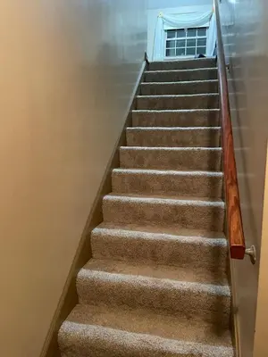 a set of stairs in a building with a door at Cozy Apartment w Garage in Salem