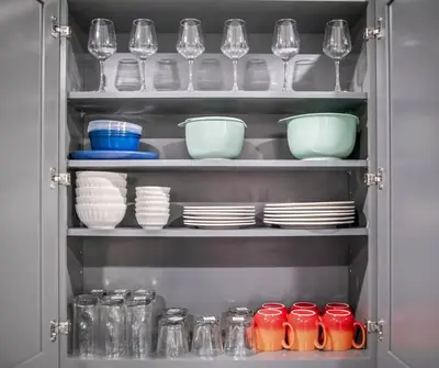 a cupboard filled with plates and glasses and dishes at Apt+ 2 Queens+Bunkbed+Free Parking 55