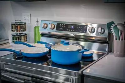 a kitchen stove with two pots and pans on it at Apt+ 2 Queens+Bunkbed+Free Parking 55