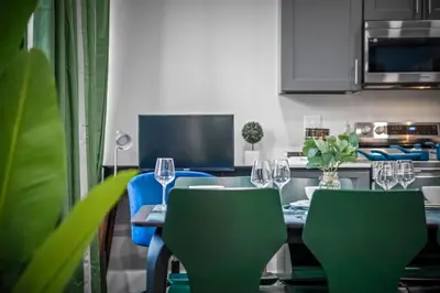 a kitchen with a table with chairs and wine glasses at Apt+ 2 Queens+Bunkbed+Free Parking 55
