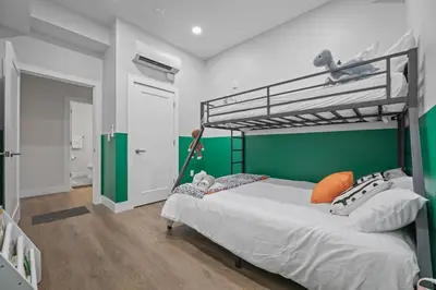 a bedroom with a bunk bed with a green wall at Stunning 2BR-1B Apt+Mins to Zoo& D/T+HD Projector in Cleveland