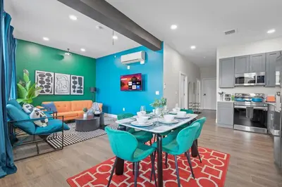 a kitchen and living room with a table and chairs at Stunning 2BR-1B Apt+Mins to Zoo& D/T+HD Projector in Cleveland