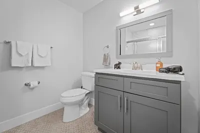 a white bathroom with a toilet and a sink at Stunning 2BR-1B Apt+Mins to Zoo& D/T+HD Projector in Cleveland