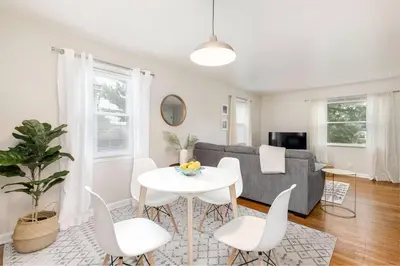a living room with a table and chairs and a couch at Bexley Breeze | High-Speed Wi-Fi | King Bed in Bexley