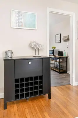a black entertainment center in a living room at Bexley Breeze | High-Speed Wi-Fi | King Bed in Bexley