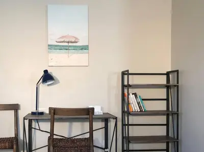 a desk with a chair and a table with an umbrella at Bexley Breeze | High-Speed Wi-Fi | King Bed in Bexley