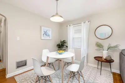 a white dining room with a white table and chairs at Bexley Breeze | High-Speed Wi-Fi | King Bed in Bexley