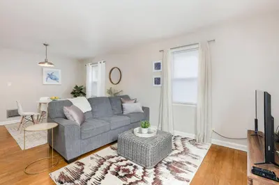 a living room with a gray couch and a table at Bexley Breeze | High-Speed Wi-Fi | King Bed in Bexley