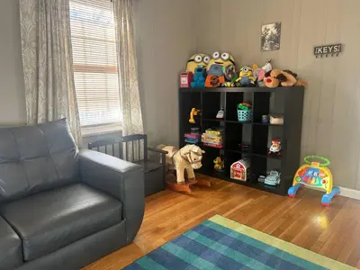 a living room with a couch and a shelf with stuffed animals at Bexley Family Friendly ★ King Bed ★ Staycation in Columbus