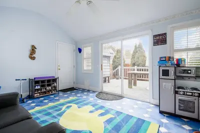 a living room with a couch and a kitchen at Bexley Family Friendly ★ King Bed ★ Staycation in Columbus