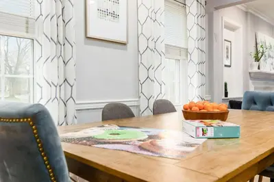 a dining room table with a bowl of oranges on it at Bexley Family Friendly ★ King Bed ★ Staycation in Columbus